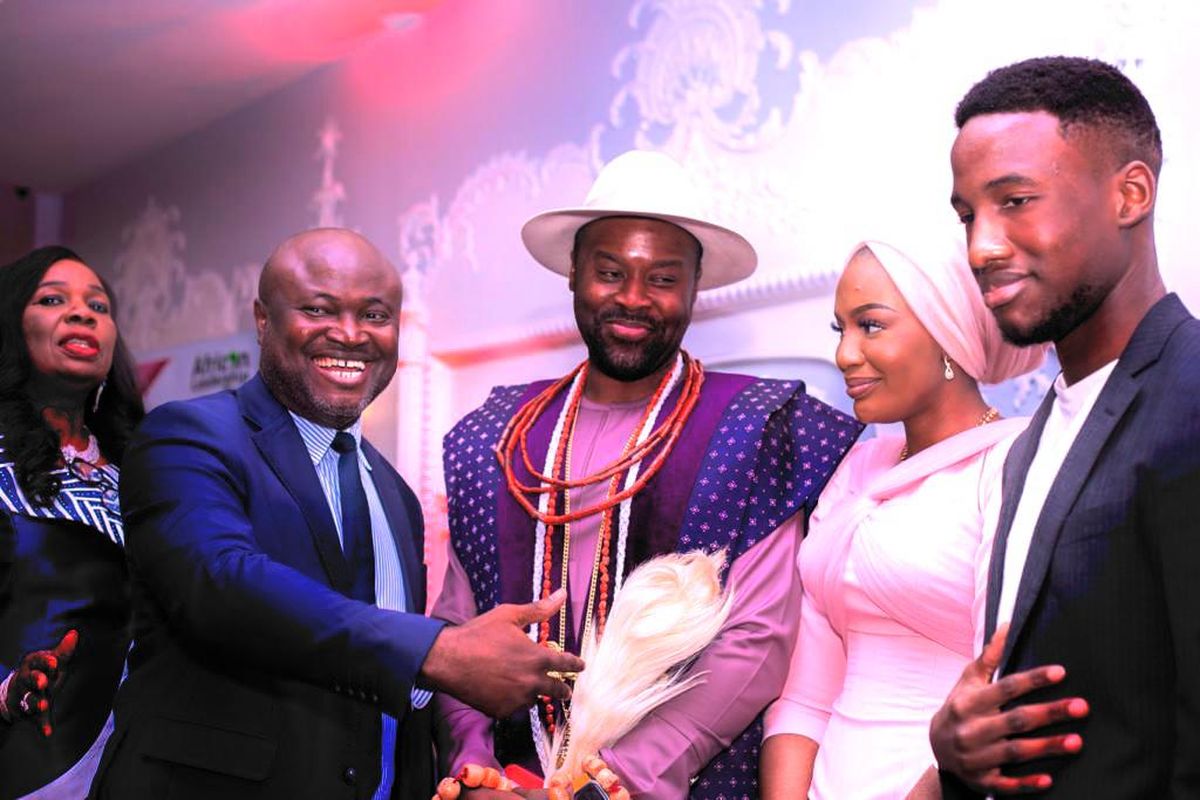 Dr. Ken Giami presenting an award to a traditional ruler and his family