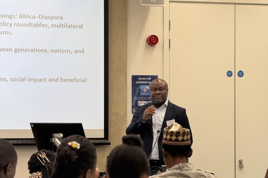 Dr. Ken Giami delivering remarks at the University of Cambridge